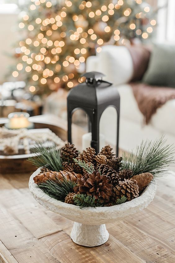 a woodland Christmas decoration of a bowl filled with evergreens and pinecones is a cool centerpiece idea