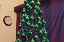 a creative Christmas tree made of green ornaments
