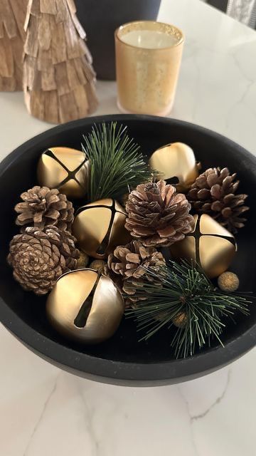 an elegant woodland Christmas decoration of a bowl with pinecones and evergreens is a cool centerpiece idea