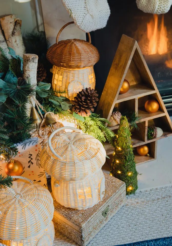 gorgeous woodland Christmas decor with woven mushroom-shaped lanterns, a frame tabletop tree and pinecones