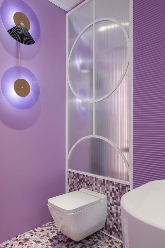 a very peri bathroom with catchy wall lamps, a white appliances and a forsted glass wall is a lovely idea