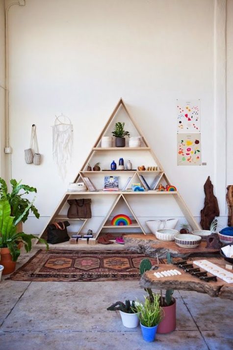a cool triangle wooden shelving unit is a great idea for a boho or modern space and isn’t difficult to DIY