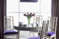 23 a chic dining space with a round grey table, grey and very peri chairs, a very peri woven pendant lamp and much light