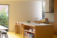25 a contemporary kitchen with plain light-stained cabinets and a kitchen island, a sunny yellow floor that makes a statement