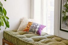 25 a cozy daybed by the window with a mattress of warma nd textural fabric is a chic and cool idea to rock