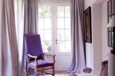 25 a delicate blush space with lavender curtains, a blush chair and a purple one, some art and lots of light