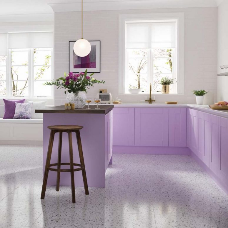 a pretty kitchen with very peri cabinets and a kitchen island, white and dark stained countertops and a matching stool