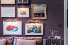 33 a refined and decadent living room with deep purple walls, a mauve leather sofa, a mini gallery wall, a gold bar cart