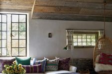 a boho living room design with wooden ceiling
