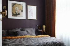 34 a sophisticated bedroom with a deep purple accent wall, a bed with printed bedding and touches of yellow for a brighter look
