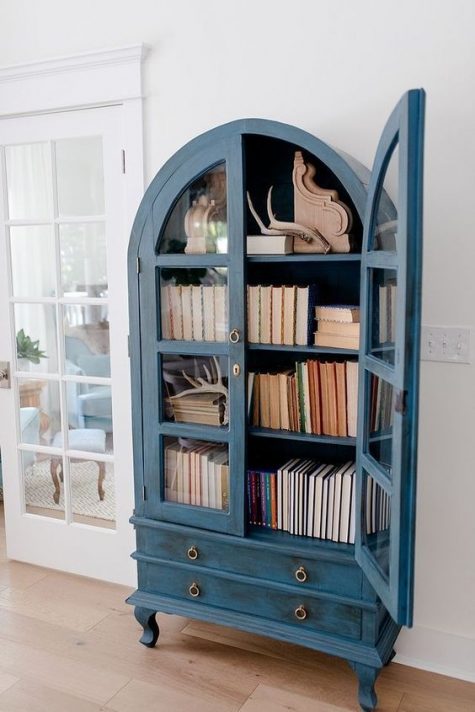 a lovely distressed blue bookcase with a couple of drawers will be a real centerpiece in the room