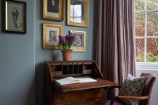 38 a sophisticated vintage dark-stained desk with elegant legs and a mauve chair that matches for a chic working space