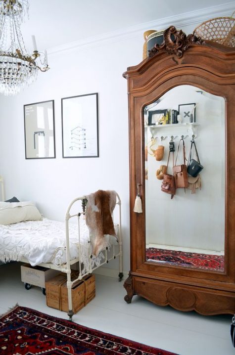 a stained vintage wardrobe with a mirror door is a gorgeous way to add chic to your bedroom or closet