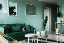 41 a cool light green living room with an emerald sofa and pillows, a Moroccan rug, simple chairs and side tables