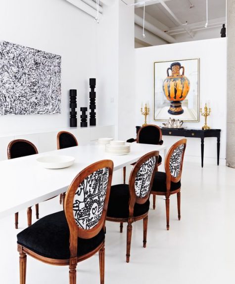 renovated vintage chairs and a black console table blend with a modern white dining table ina beautiful way