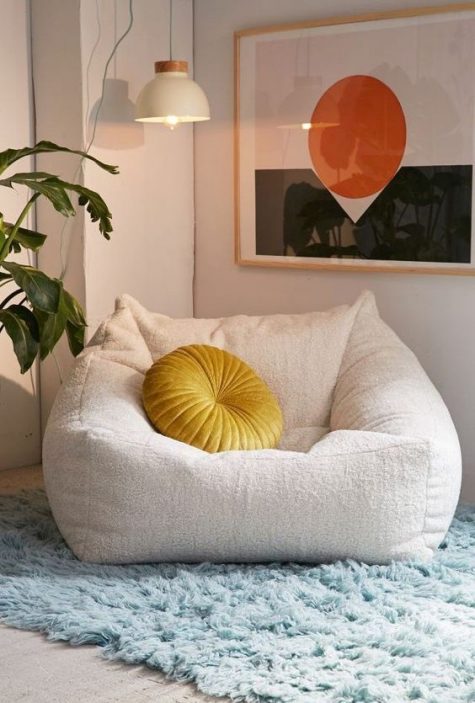 create your own welcoming space with such a lovely and soft chair with a bright pillow and rug and make it your perfect spot