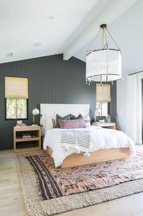 a chic farmhouse bedroom done with a black shiplap statement wall that adds drama and elegance to the space