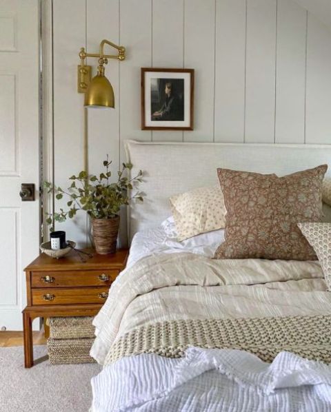 an airy neutral bedroom design with a wood wall