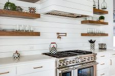 a cozy farmhouse kitchen design with wood walls