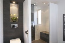 a modern minimalist bathroom design with taupe flooring