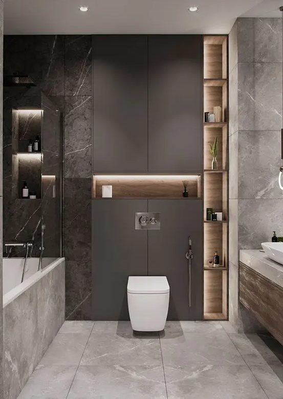 a sophisticated grey bathroom with a sleek taupe panel, built-in lights, white appliances and marble and stone tiles is amazing