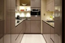 a super sleek and glossy taupe kitchen with no handles and built-in lights, with a pastel yellow sleek backsplash and countertops