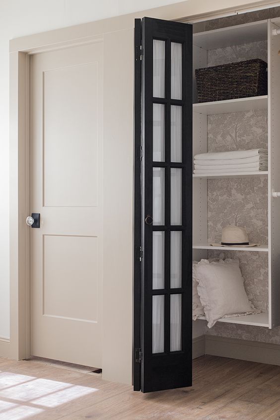 add a black frame French folding door to hide your closet or another built-in storage space with style