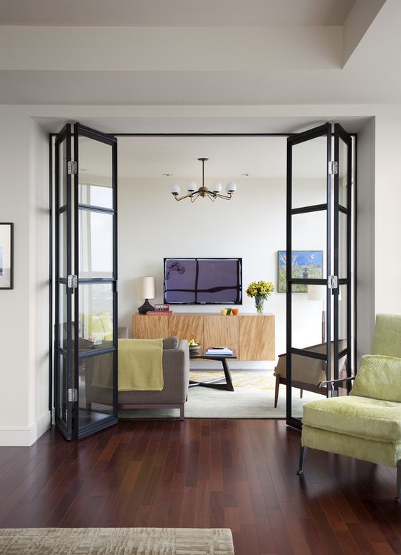 black frame glass folding doors like these ones break up the space without diminishing light and sight lines and make it airy