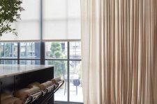 blinds paired with elegant and a bit shiny neutral curtains give a chic and beautiful touch to the space