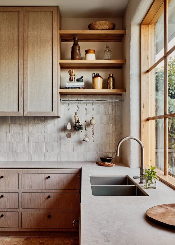 cane, wood, Zellige tiles and concrete countertops make the kitchen look catchy and interesting due to the textures