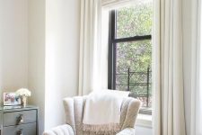 neutral printed blinds and creamy curtains create a beautiful and airy look adding a soothing touch to the room