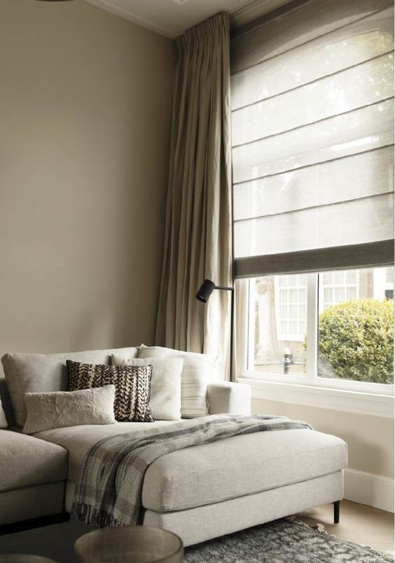 neutral striped blinds paired with curtains that match in color look cool and soothing together and add coziness to the room