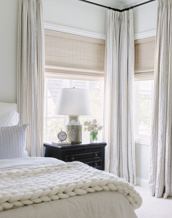 neutral woven blinds add texture to the space and creamy curtains are perfect for adding elegance to the room