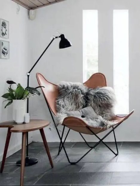 a stylish nook with a leather chair, a floor lamp and a side table is ideal for reading - just add pillows