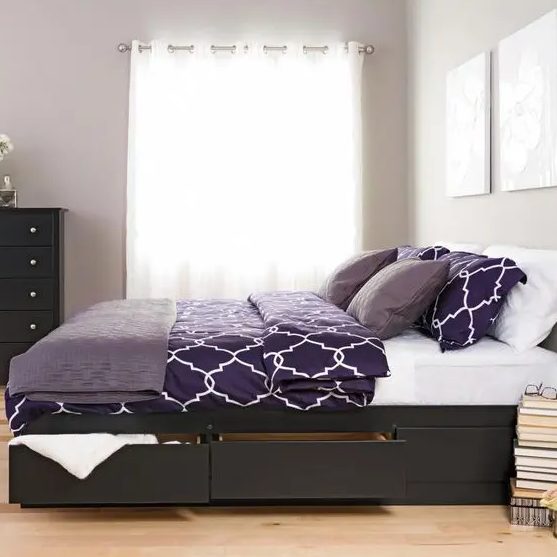a minimalist dark stained bed with side drawers to hide various stuff you don't need at the moment