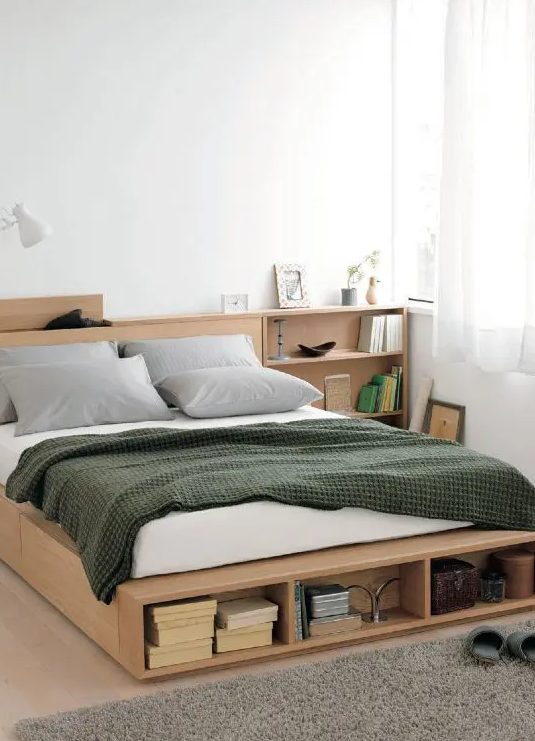 a minimalist light-stained bed with side drawers and an open storage compartment at the foot of the bed plus storage nightstands is a cool solution for a small bedroom