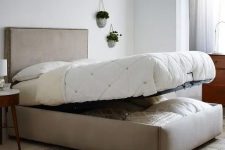 15 a neutral upholstered bed that can be raised to store some things inside it is an ultimate idea to rock
