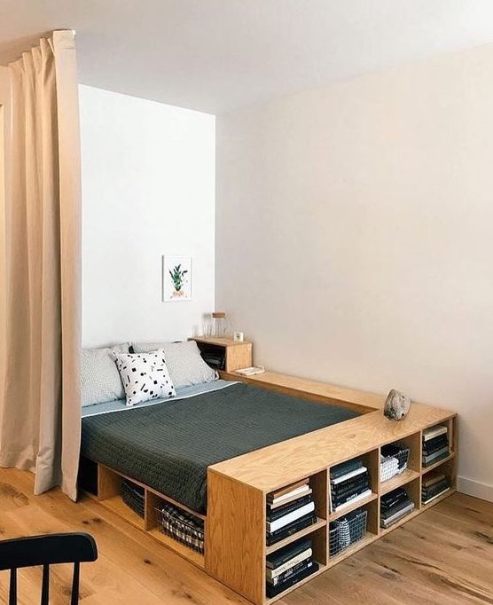 a plywood bed with plenty of storage - open storage compartments and an additional nightstand