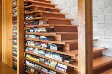 19 a contemporary light-stained staircase that includes enough space for storing books due to the two-sided steps