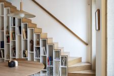 20 a contemporary light-stained staircase with shelves built in, both for books and other items for displaying