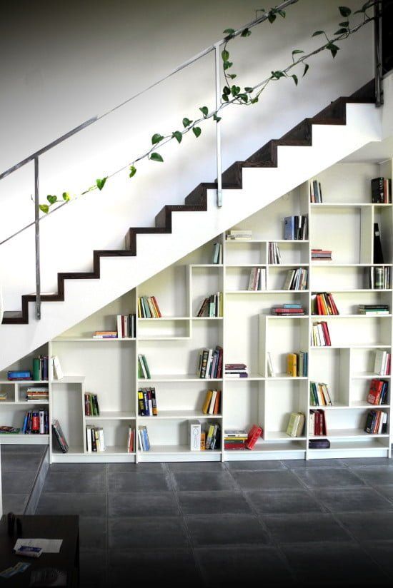a modern black and white staircase with IKEA Billy bookcases built into it is a stylish idea and a fresh IKEA hack