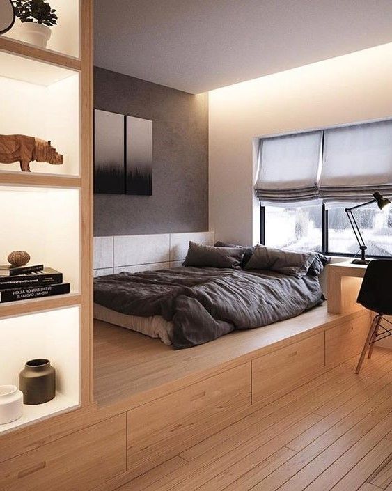 a contemporary bedroom with a platform bed with storage drawers, additional storage compartments on the left of the bed