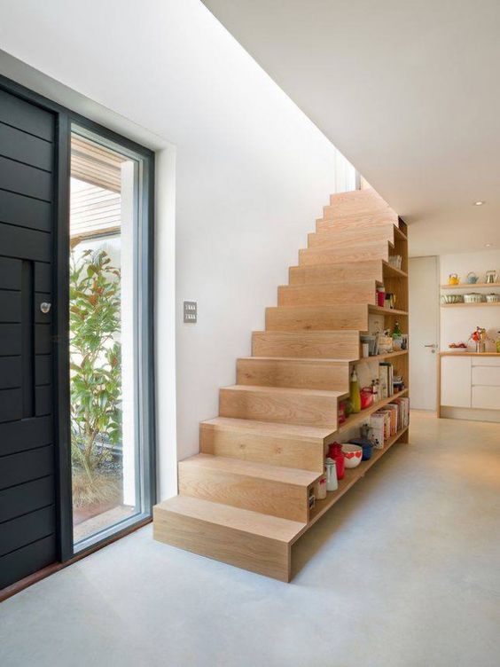 a practical staircase with open shelves for books and for displaying various objects is a very cool and up to date idea