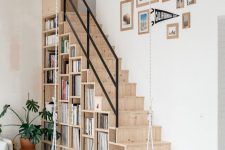 27 a Scandinavian space with a light-stained staircase, with shelves built-into it for a practical use is all cool