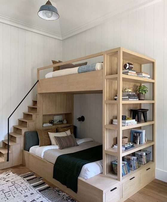 a light stained bunk bed with open shelving and drawers for storage is a cool modern solution for a small kids' room