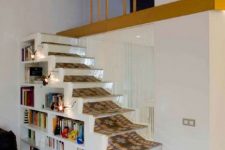 28 a small and low staircase with built-in bookshelves and a bold carpet is a lovely decor feature and a very practical idea