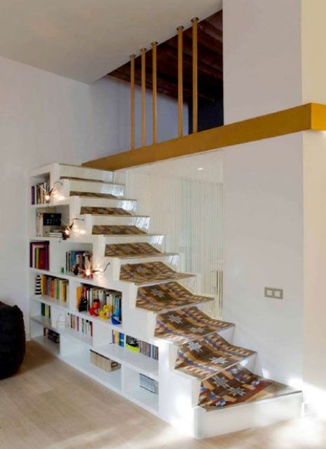 a small and low staircase with built-in bookshelves and a bold carpet is a lovely decor feature and a very practical idea