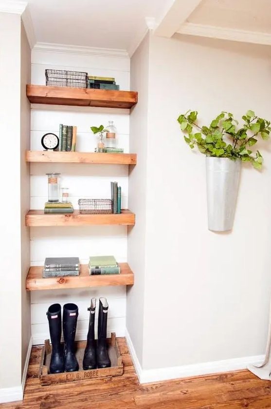 a small awkward nook taken by open shelves and is used for storage to make the use of it