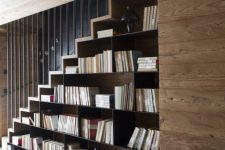 29 a stained staircase with lots of bookshelves under it is a cool idea for any space, here it’s integrated into a chalet home