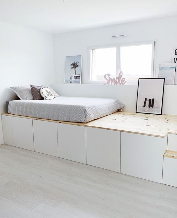 a neutral bedroom with a platform bed that shows off a lot of storage space underneath is a very creative idea